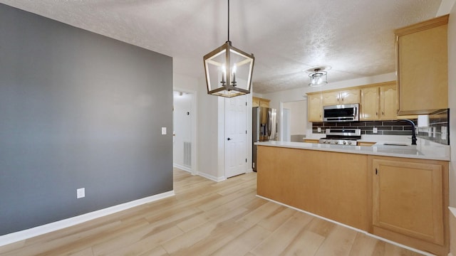 618 Cookstown Dr, Smyrna, TN 37167 - kitchen featuring appliances with stainless steel finishes, a sink, a textured ceiling, light brown cabinetry, and light wood-style flooring