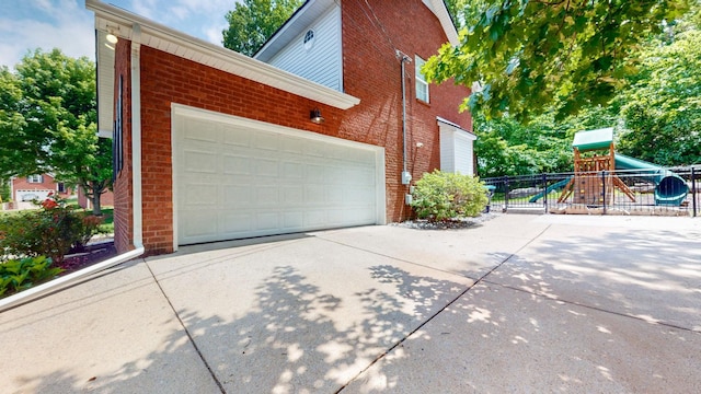 618 Cookstown Dr, Smyrna, TN 37167 - view of side of property featuring brick siding, concrete driveway, fence, a playground, and a garage