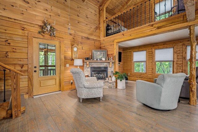 154 Whitetail Ln, Belvidere, TN 37306 - living area with wood-type flooring, a fireplace, wooden walls, high vaulted ceiling, and beamed ceiling