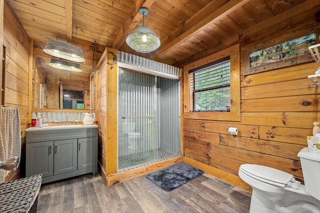154 Whitetail Ln, Belvidere, TN 37306 - bathroom with vanity, a stall shower, toilet, wood finished floors, and wooden walls