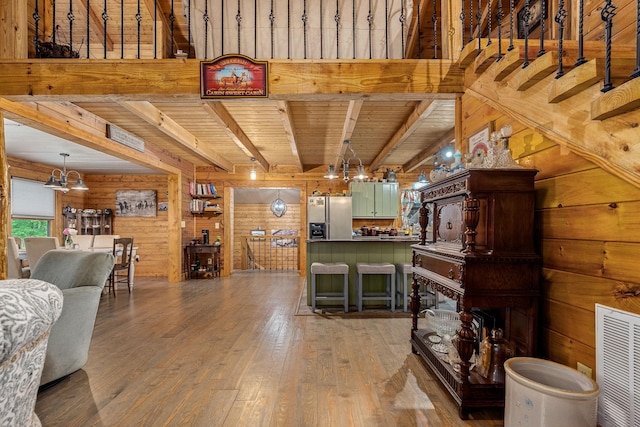154 Whitetail Ln, Belvidere, TN 37306 - living area featuring wooden walls, light wood-type flooring, wooden ceiling with exposed beams, and a chandelier