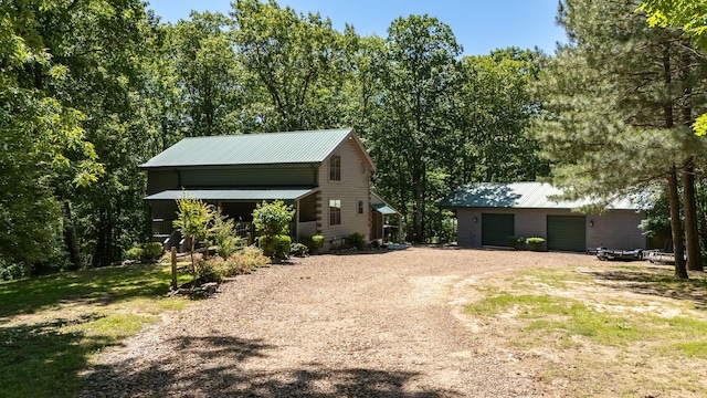 154 Whitetail Ln, Belvidere, TN 37306 - view of front of property with an outbuilding, dirt driveway, metal roof, and a garage