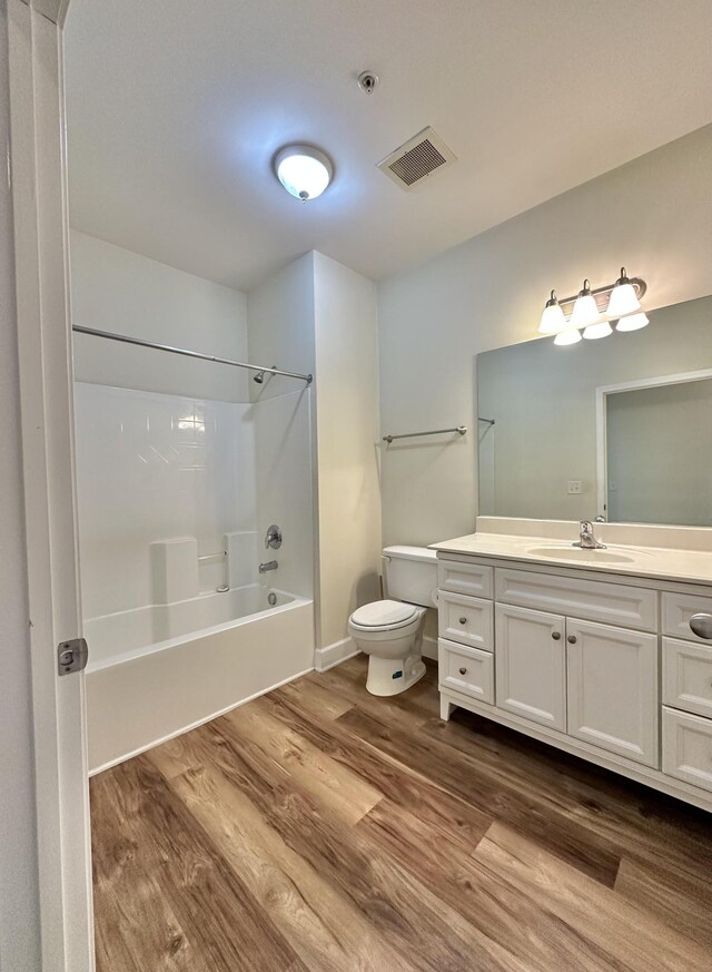 8501 Burnham Ln Unit 6, Antioch, TN 37013 - bathroom featuring toilet, wood finished floors, vanity, and bathtub / shower combination
