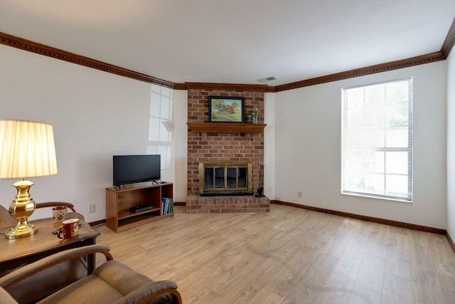 living area featuring crown molding, baseboards, a brick fireplace, and light wood-style flooring