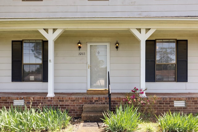 doorway to property featuring covered porch and crawl space