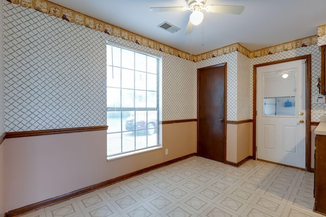 entryway with ceiling fan, wallpapered walls, baseboards, and light flooring