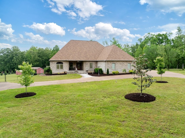 575 Homestead Ln, Henderson, TN 38340 - view of front of home featuring curved driveway, a front yard, roof with shingles, and brick siding
