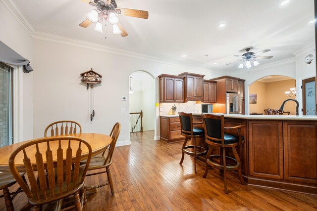 575 Homestead Ln, Henderson, TN 38340 - kitchen featuring ceiling fan, arched walkways, high end fridge, hardwood / wood-style flooring, and ornamental molding