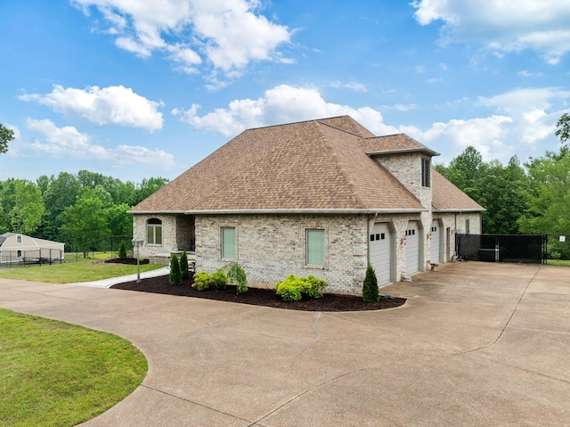 575 Homestead Ln, Henderson, TN 38340 - view of front facade featuring roof with shingles, driveway, a garage, and brick siding