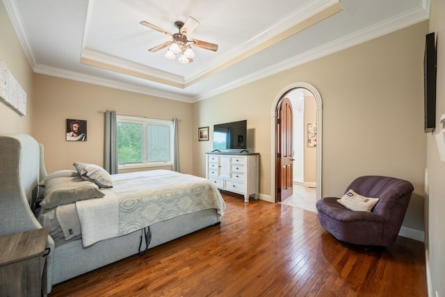575 Homestead Ln, Henderson, TN 38340 - bedroom featuring a raised ceiling, hardwood / wood-style flooring, arched walkways, ornamental molding, and baseboards