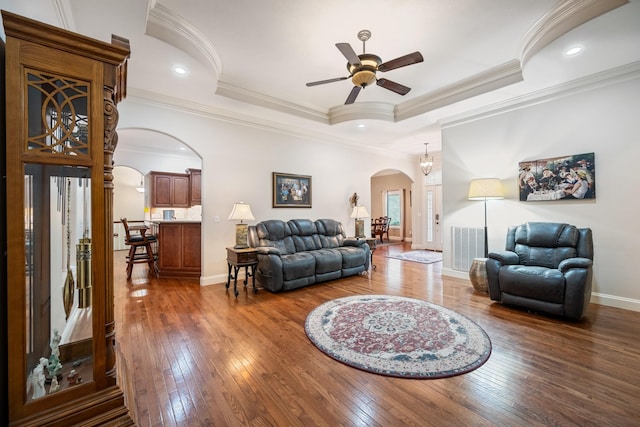 575 Homestead Ln, Henderson, TN 38340 - living area featuring arched walkways, a ceiling fan, hardwood / wood-style floors, a tray ceiling, and crown molding