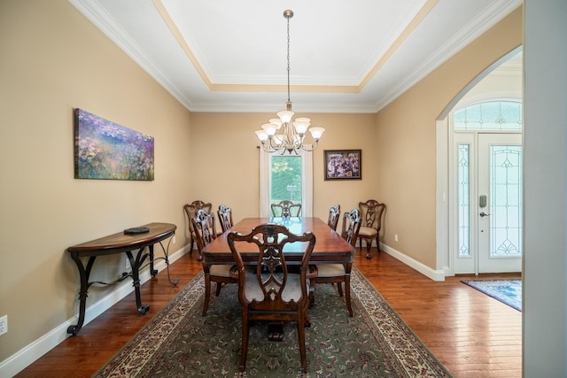 575 Homestead Ln, Henderson, TN 38340 - dining area featuring a chandelier, a raised ceiling, dark wood-style floors, crown molding, and baseboards