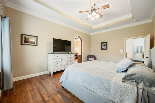 575 Homestead Ln, Henderson, TN 38340 - bedroom featuring a raised ceiling, dark wood-style flooring, baseboards, ornamental molding, and arched walkways