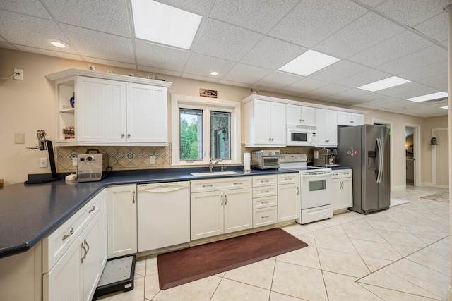 575 Homestead Ln, Henderson, TN 38340 - kitchen featuring white appliances, a sink, backsplash, dark countertops, and open shelves