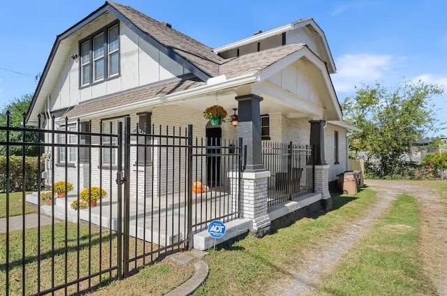 1822 Jefferson St, Nashville, TN 37208 - view of side of property with covered porch, board and batten siding, a shingled roof, and brick siding