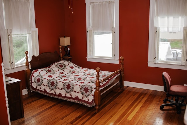 209 Main St, Cumberland City, TN 37050 - bedroom featuring hardwood / wood-style floors, multiple windows, and baseboards