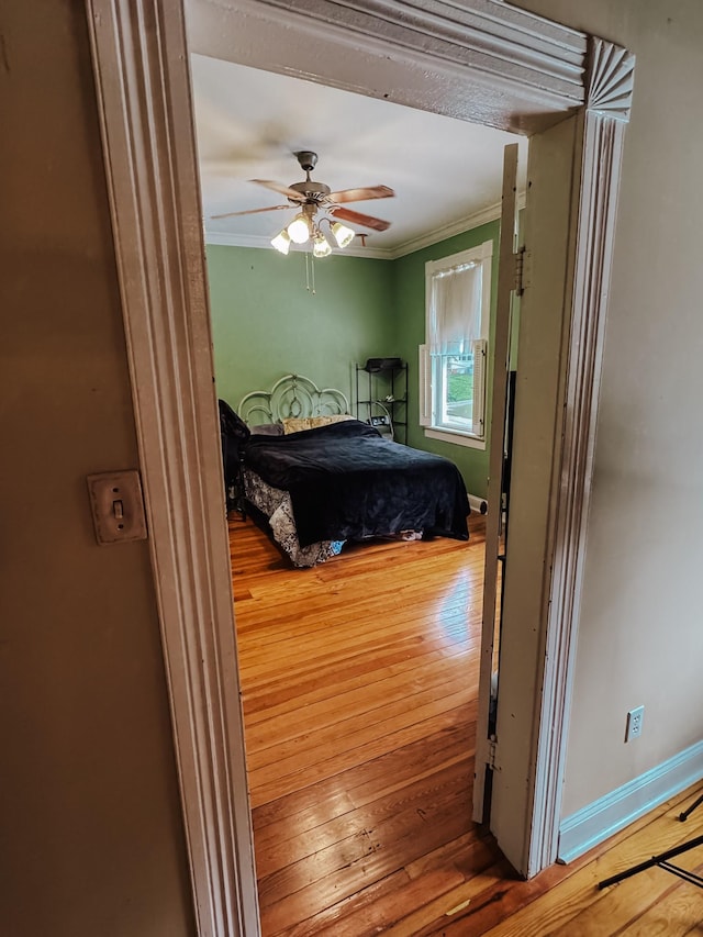 209 Main St, Cumberland City, TN 37050 - bedroom featuring ornamental molding, wood finished floors, baseboards, and ceiling fan