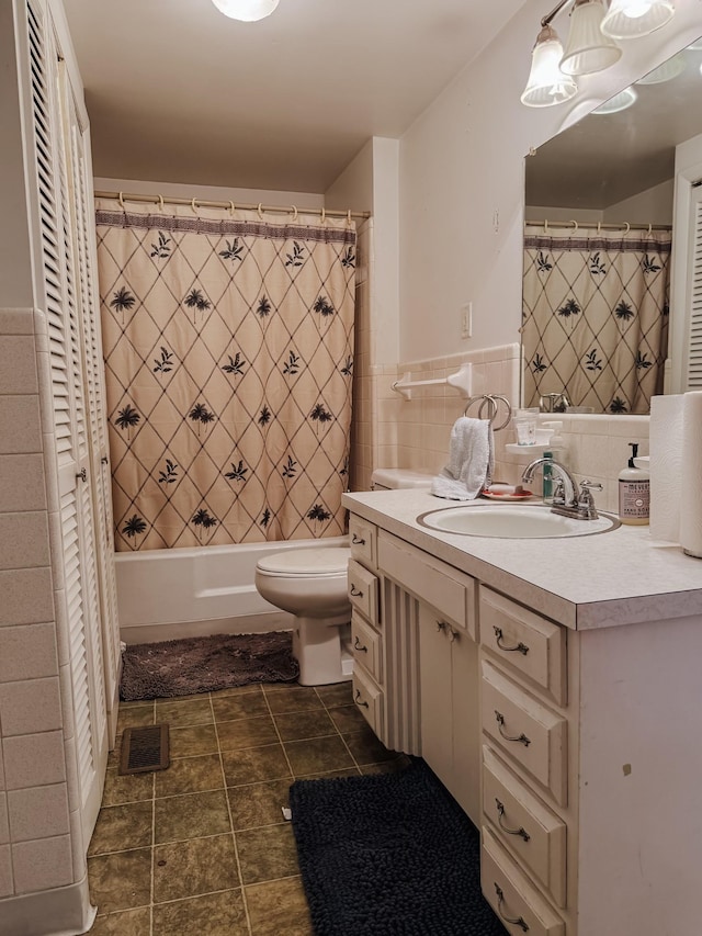 209 Main St, Cumberland City, TN 37050 - full bathroom with vanity, toilet, a closet, tile walls, and shower / bath combo