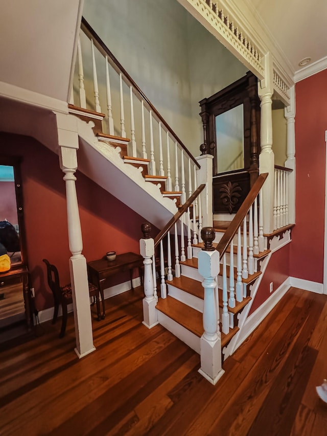 209 Main St, Cumberland City, TN 37050 - staircase featuring wood finished floors, baseboards, and crown molding