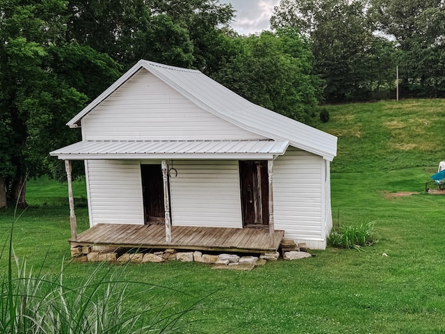 209 Main St, Cumberland City, TN 37050 - view of front facade featuring a front lawn and metal roof