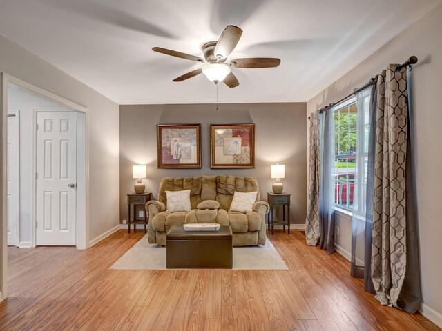 100 Oak Ave, Dickson, TN 37055 - living room with ceiling fan, light wood-style floors, and baseboards