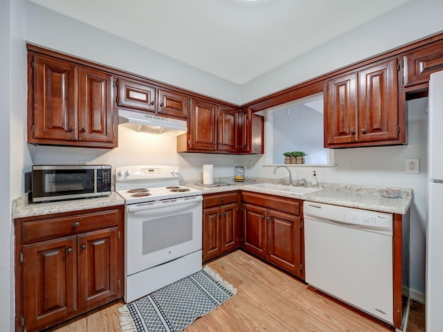 100 Oak Ave, Dickson, TN 37055 - kitchen with white appliances, a sink, under cabinet range hood, and light wood-type flooring