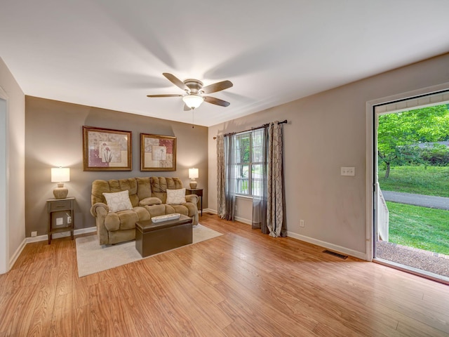 100 Oak Ave, Dickson, TN 37055 - living room featuring light wood-style flooring, ceiling fan, and baseboards