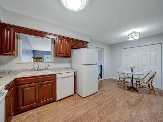 100 Oak Ave, Dickson, TN 37055 - kitchen featuring white appliances, a sink, light countertops, and light wood-style floors