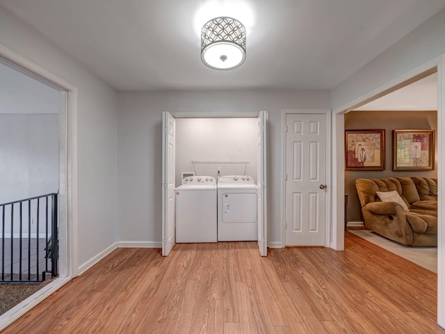 100 Oak Ave, Dickson, TN 37055 - washroom featuring washer and clothes dryer, light wood-type flooring, and baseboards