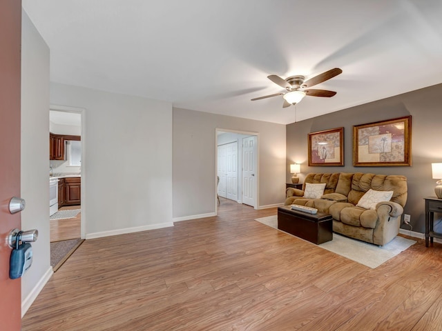 100 Oak Ave, Dickson, TN 37055 - living room featuring ceiling fan, light wood finished floors, and baseboards