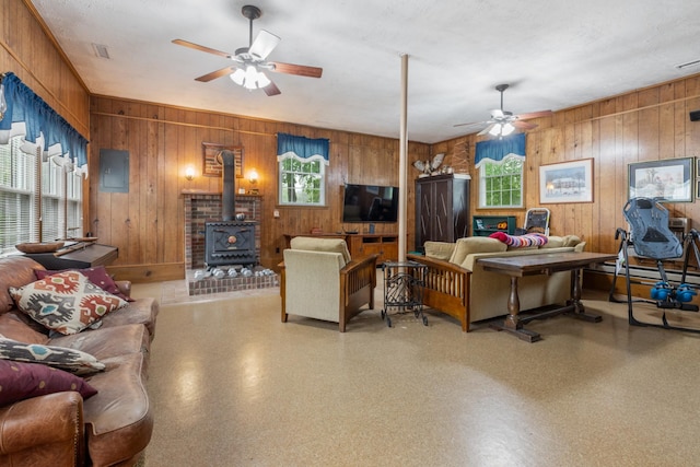 103 Forrest Hills Dr, Dickson, TN 37055 - living area with a ceiling fan, wooden walls, and a wood stove