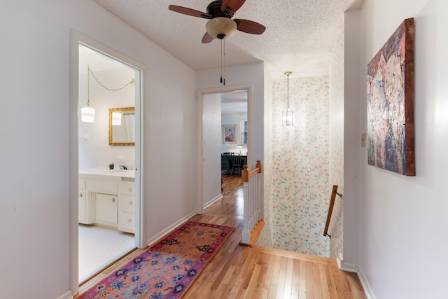 103 Forrest Hills Dr, Dickson, TN 37055 - hallway with an upstairs landing, light wood finished floors, baseboards, and a textured ceiling