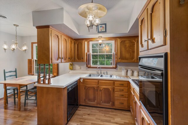 103 Forrest Hills Dr, Dickson, TN 37055 - kitchen with a chandelier, black appliances, a sink, and a peninsula