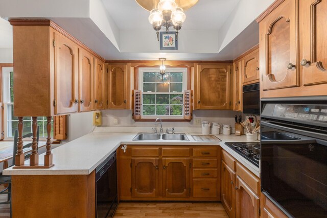 103 Forrest Hills Dr, Dickson, TN 37055 - kitchen with a sink, black appliances, a chandelier, light countertops, and light wood-type flooring