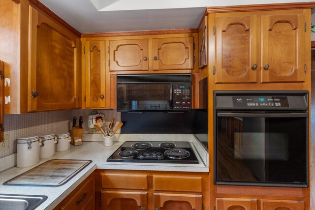 103 Forrest Hills Dr, Dickson, TN 37055 - kitchen with black appliances, light countertops, brown cabinetry, and backsplash