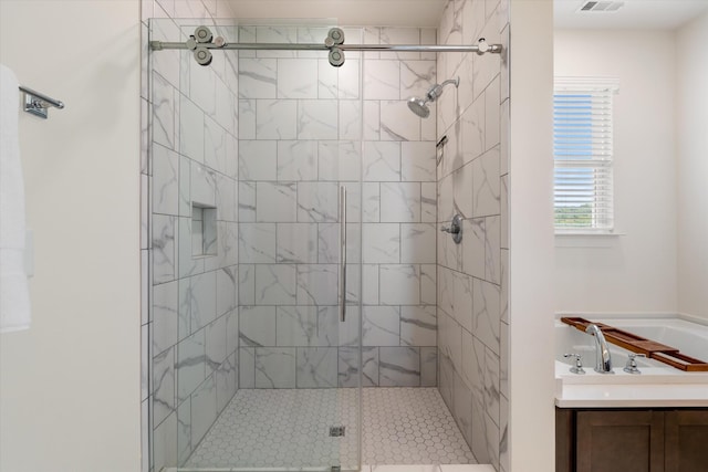 bathroom featuring a stall shower and vanity