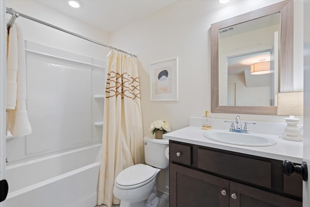 bathroom with toilet, vanity, and shower / tub combo