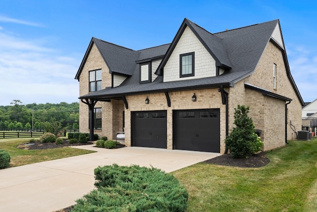 view of home's exterior featuring driveway, an attached garage, brick siding, and roof with shingles