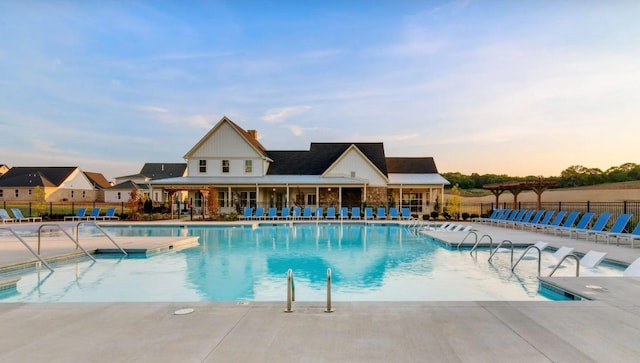 community pool with fence and a patio