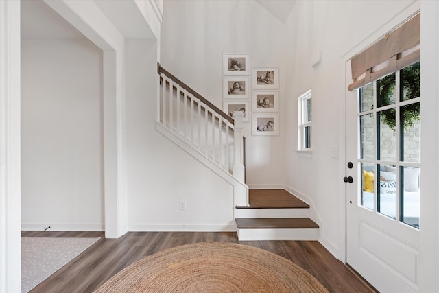 foyer with wood finished floors and stairs