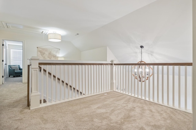additional living space featuring carpet, attic access, and lofted ceiling