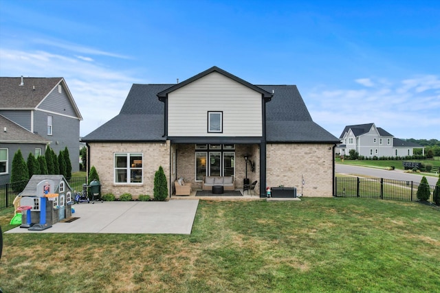 rear view of property featuring a patio area, brick siding, and outdoor lounge area