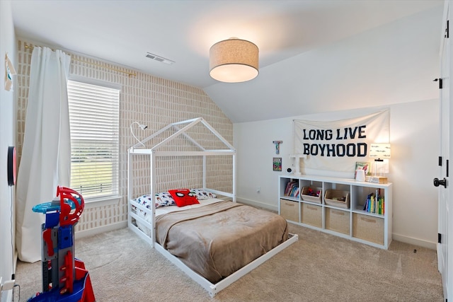 carpeted bedroom with lofted ceiling and baseboards
