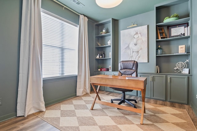 office featuring baseboards and light wood-style floors