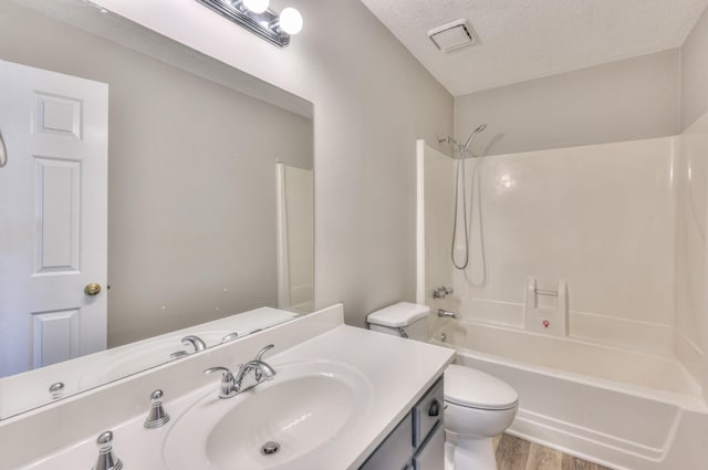 1716 Golden Valley Dr, Christiana, TN 37037 - full bathroom with toilet, wood finished floors, vanity, bathing tub / shower combination, and a textured ceiling