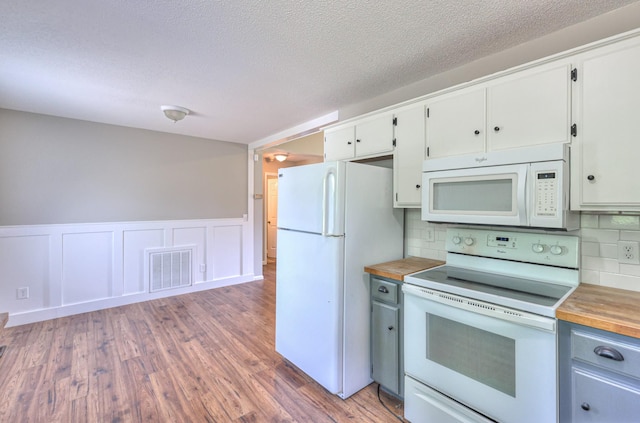 1716 Golden Valley Dr, Christiana, TN 37037 - kitchen featuring white appliances, butcher block counters, light wood-style flooring, tasteful backsplash, and white cabinets