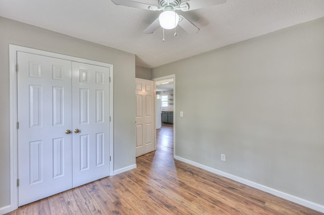 1716 Golden Valley Dr, Christiana, TN 37037 - unfurnished bedroom with baseboards, wood finished floors, a closet, and a ceiling fan