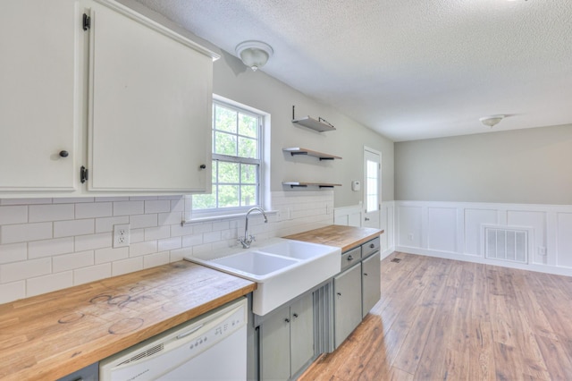 1716 Golden Valley Dr, Christiana, TN 37037 - kitchen with dishwasher, wooden counters, a textured ceiling, light wood-style flooring, and tasteful backsplash
