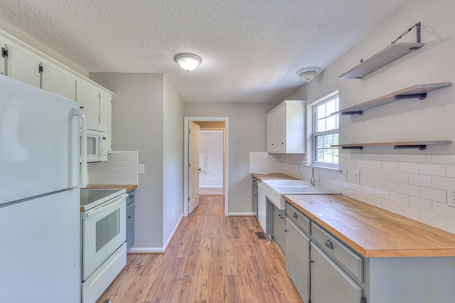 1716 Golden Valley Dr, Christiana, TN 37037 - kitchen featuring white appliances, a sink, tasteful backsplash, light wood-style flooring, and a textured ceiling