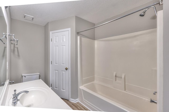 1716 Golden Valley Dr, Christiana, TN 37037 - bathroom with a sink, wood finished floors,  shower combination, a textured ceiling, and toilet